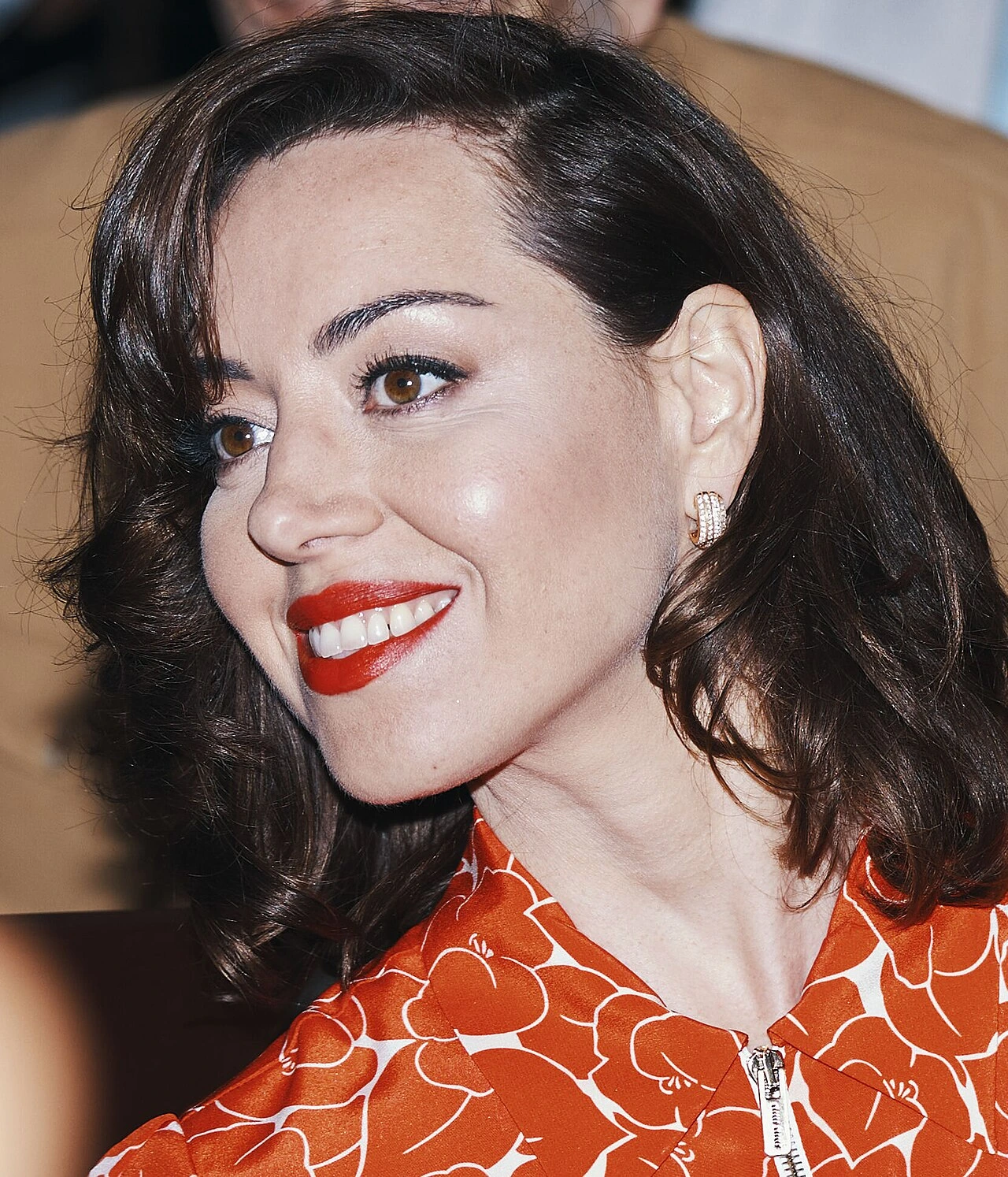 Aubrey Plaza smiling on the red carpet at the 2024 Cannes Film Festival.